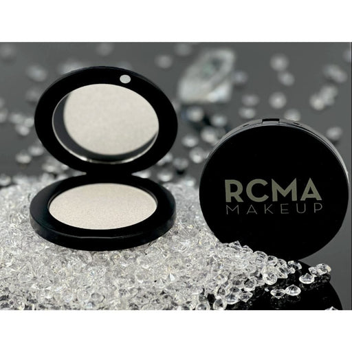 RCMA Diamond Lights Pressed Powder open laying on diamonds and a closed compact showing name