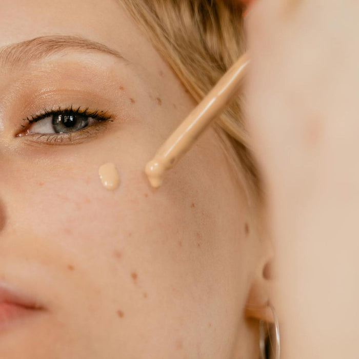 Women Applying Foundation On Her Face