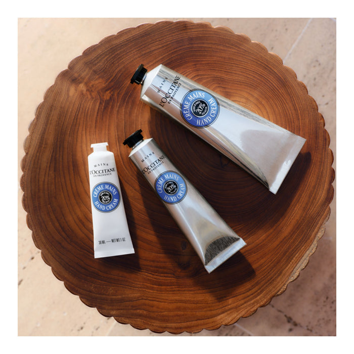 L'Occitane Shea Butter Hand Cream all sizes styled on treated wood.