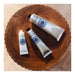 L'Occitane Shea Butter Hand Cream all sizes styled on treated wood.