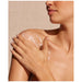 Natura Bisse Diamond Body Rejuvenating Body Cream being applied by model onto the shoulder