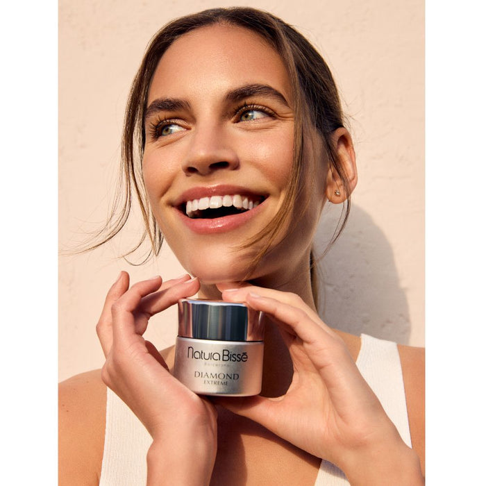 Natura Bisse Diamond Extreme Cream Rich Texture Woman holding product and smiling