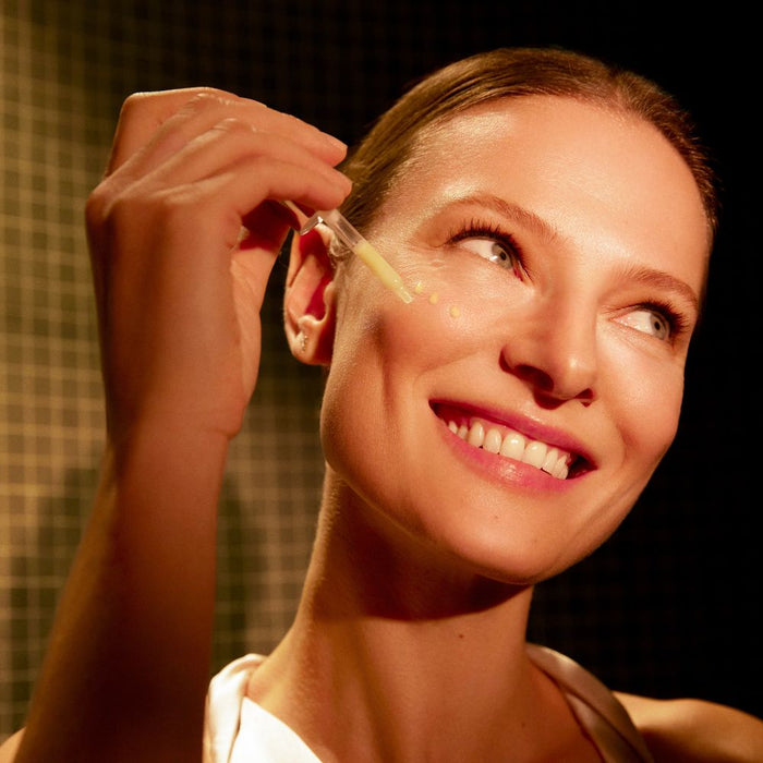 Natura Bisse Essential Shock Intense Retinol Night Renewal being used by female model on face smiling