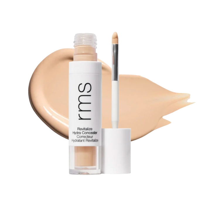 RMS Revitalize Hydra Concealer with swatch behind product against white background.