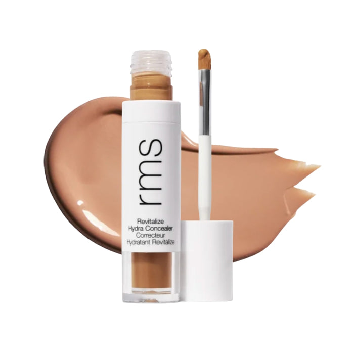 RMS Revitalize Hydra Concealer with swatch behind product against white background.