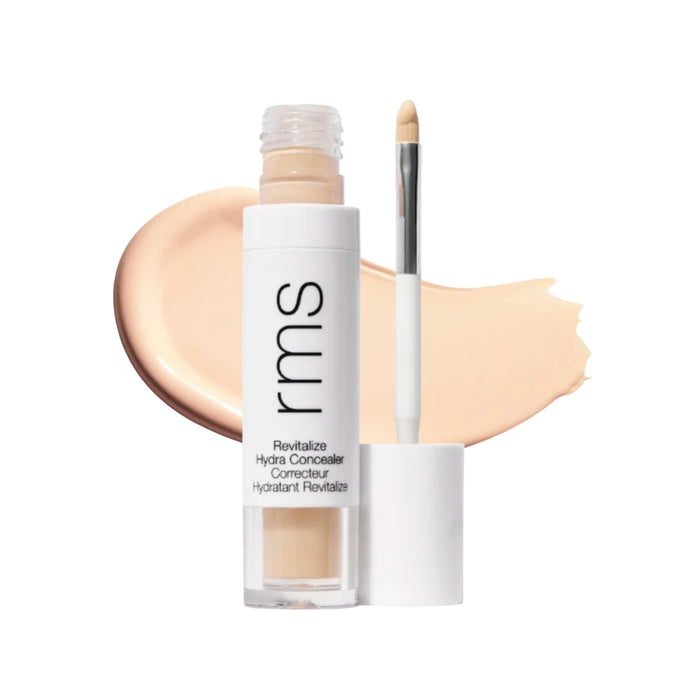 RMS Revitalize Hydra Concealer with swatch behind product against white background.