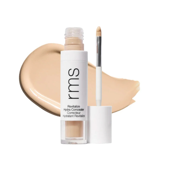 RMS Revitalize Hydra Concealer with swatch behind product against white background.