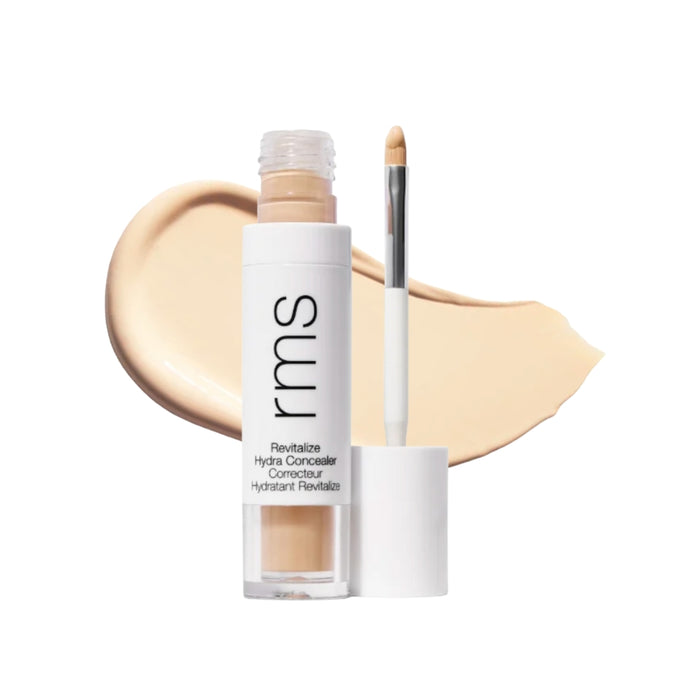 RMS Revitalize Hydra Concealer with swatch behind product against white background