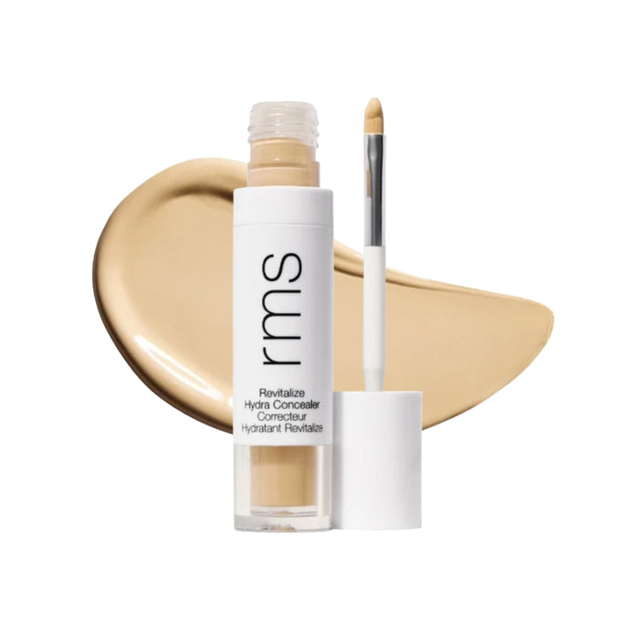 RMS Revitalize Hydra Concealer with swatch behind product against white background.
