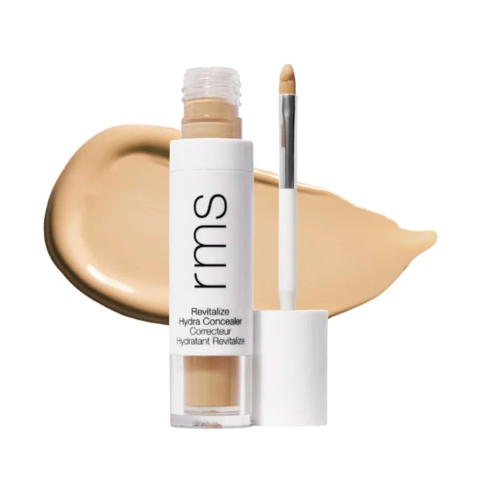 RMS Revitalize Hydra Concealer with swatch behind product against white background.