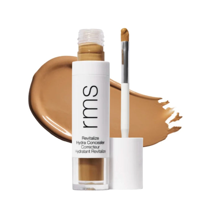 RMS Revitalize Hydra Concealer with swatch behind product against white background.