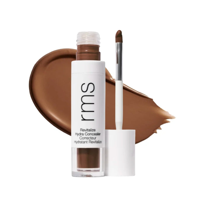 RMS Revitalize Hydra Concealer with swatch behind product against white background.