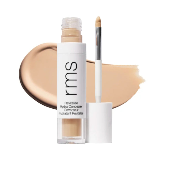 RMS Revitalize Hydra Concealer with swatch behind product against white background.