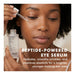 Skyn Iceland Brightening Eye Serum main benefits text under model applying product around her eye