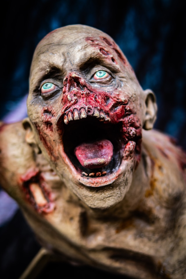 Halloween makeup of a decaying ghoul with flesh wounds and blood