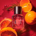 RMS Eau De Parfum Scarlet Moon stylized blood orange and mandarin on red background