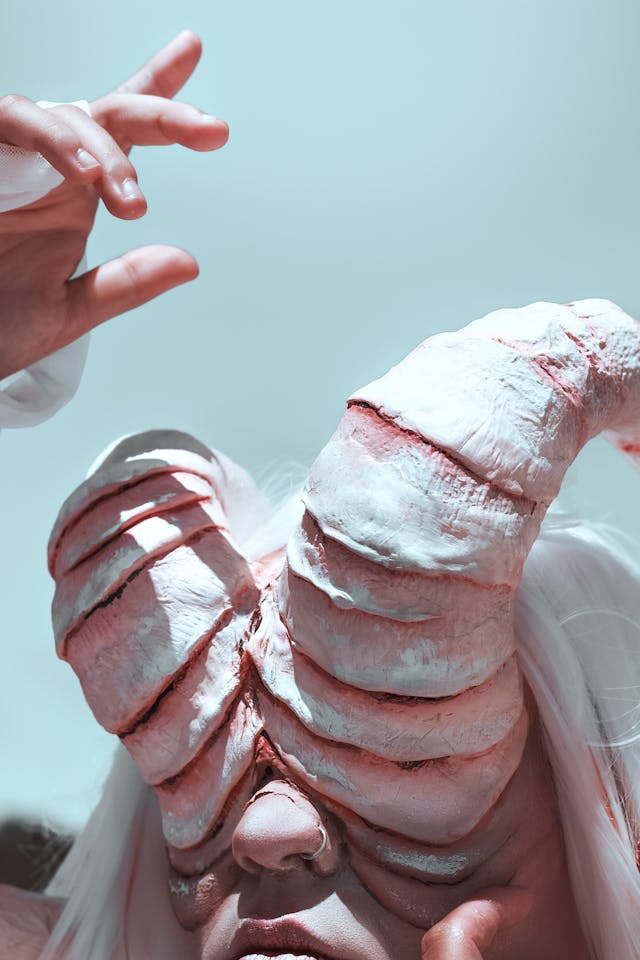 Woman wearing SFX horns made from plaster bandages sprouting from her eyes
