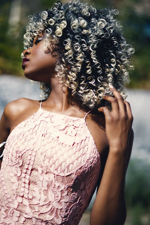 Woman with curly hair and a pink top