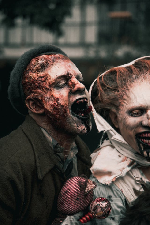 People dressed as realistic zombies with prosthetic appliances